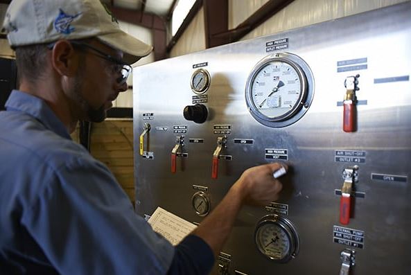 a man controlling a hydrostatic testing unit