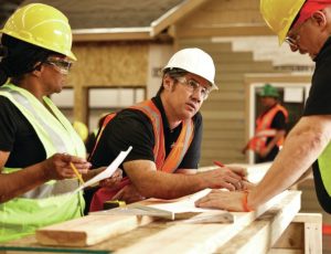 construction workers holding a tool box talk