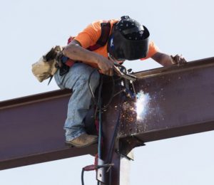 construction welder working on a beam