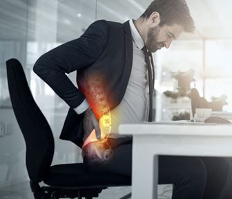 Ergonomics office worker with a bad back sitting at his desk