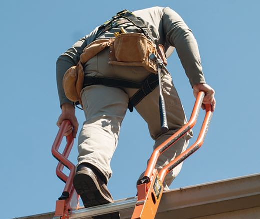 climbing-off-a-ladder-onto-the-roof-of-a-building