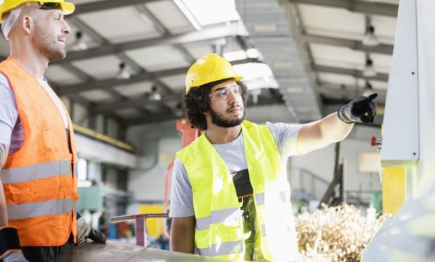 2 employees checking the process machinery