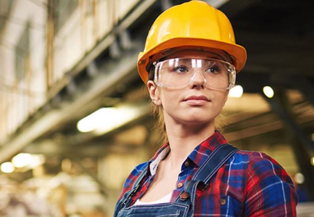 female worker wearing safety glasses at work