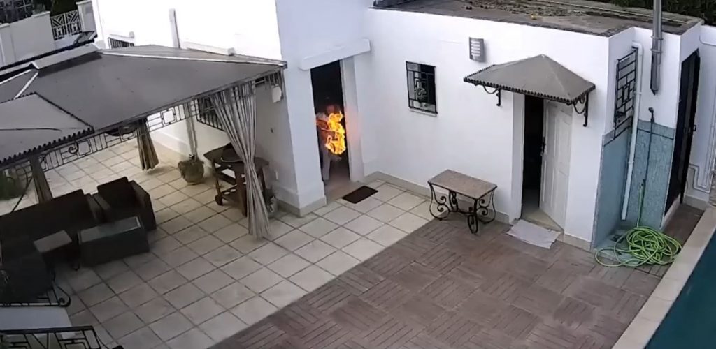 women trying to throw out the house a cooking pot on fire