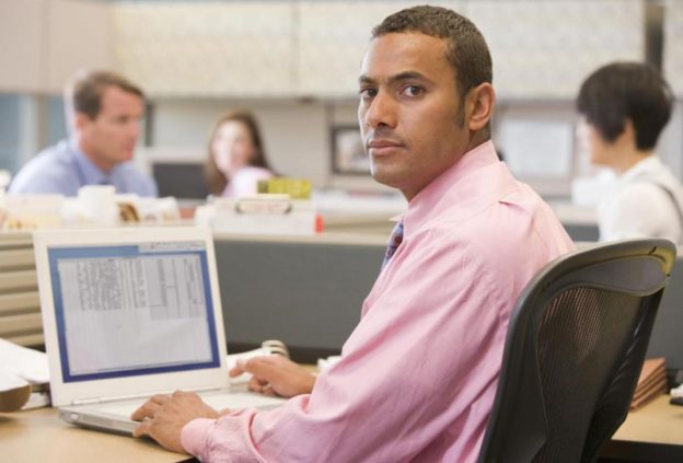 worried worker checking his personal space whilst working