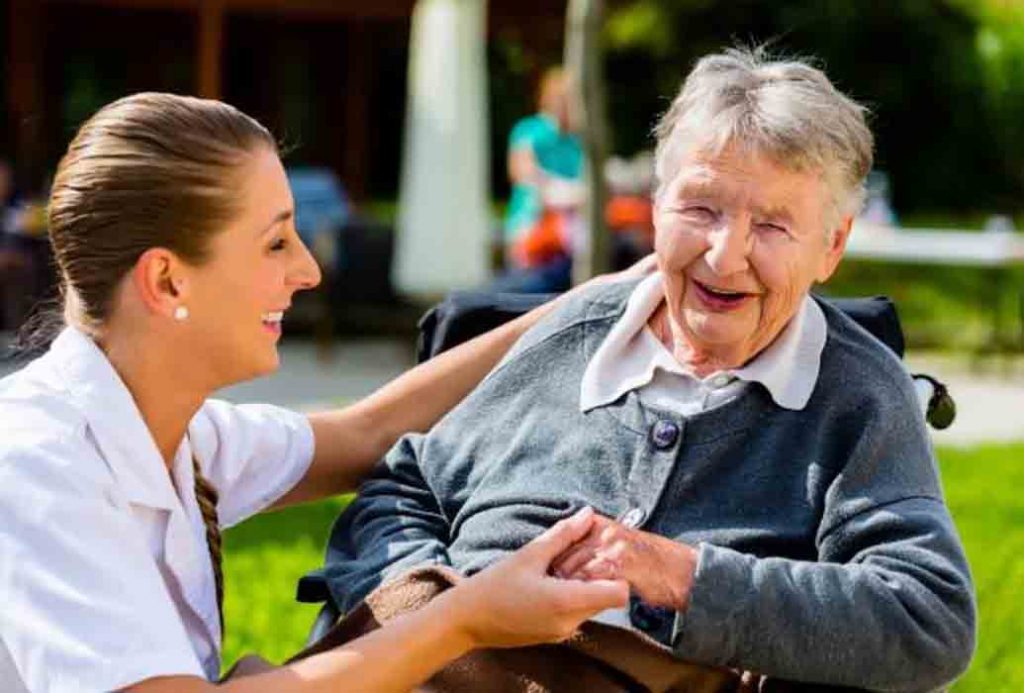 a laughing senior with her care worker