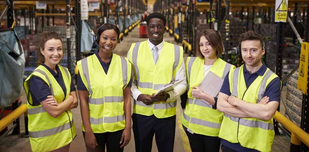 manager with employees in a warehouse