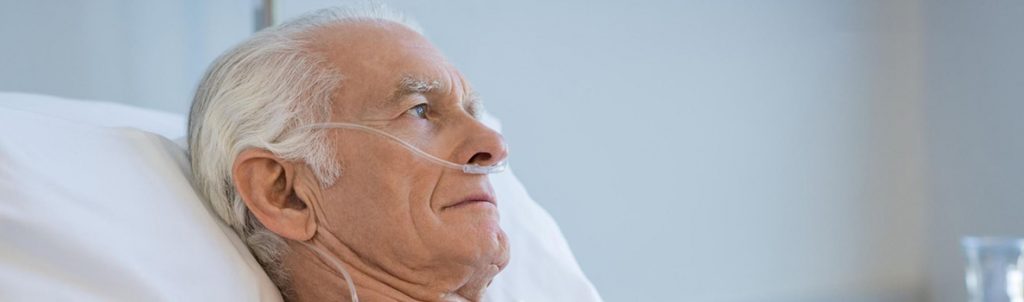 a man in bed having oxygen therapy