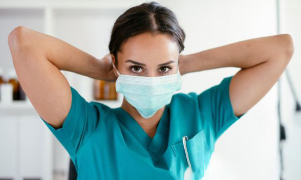 health worker putting on a surgical mask