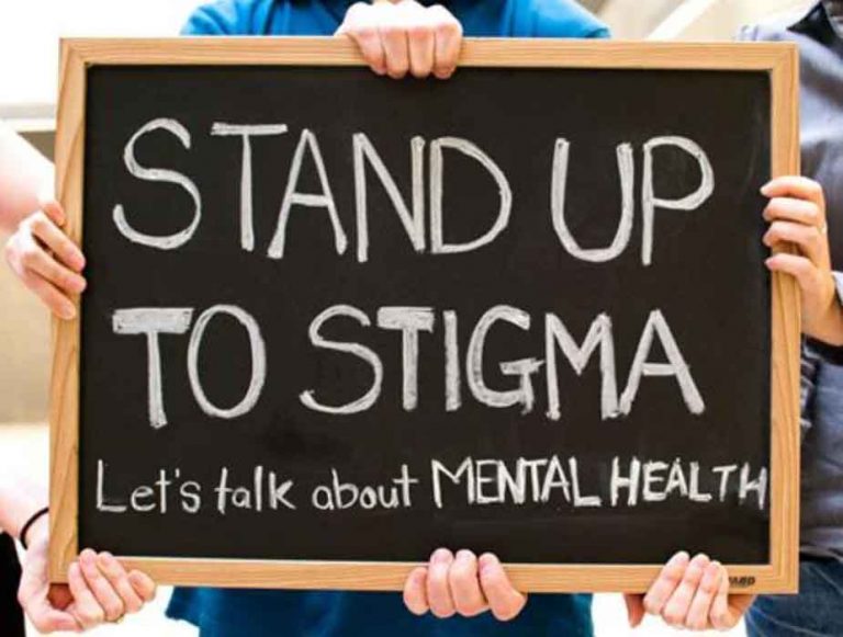 stand up to stigma signboard held by several people