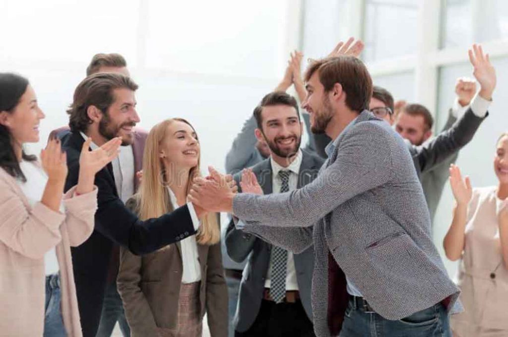a team of employees congratulating an employee on his promotion
