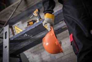 a worker preparing to start work in full PPE