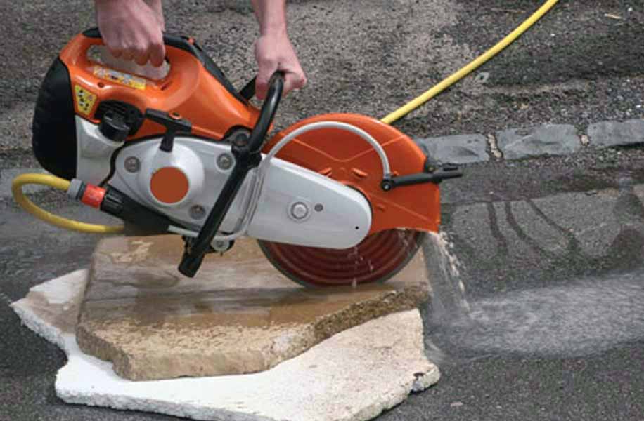 cutting stone on the ground using a disc cutter